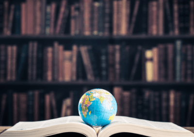 A book open with a globe on top